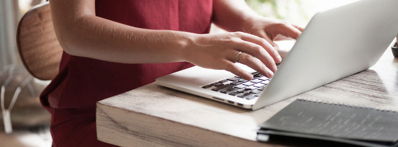 young-woman-freelancer-typing Female digital nomad