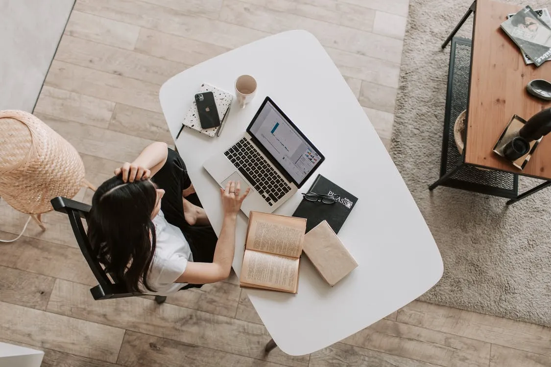 Young woman searching for apartments on a laptop