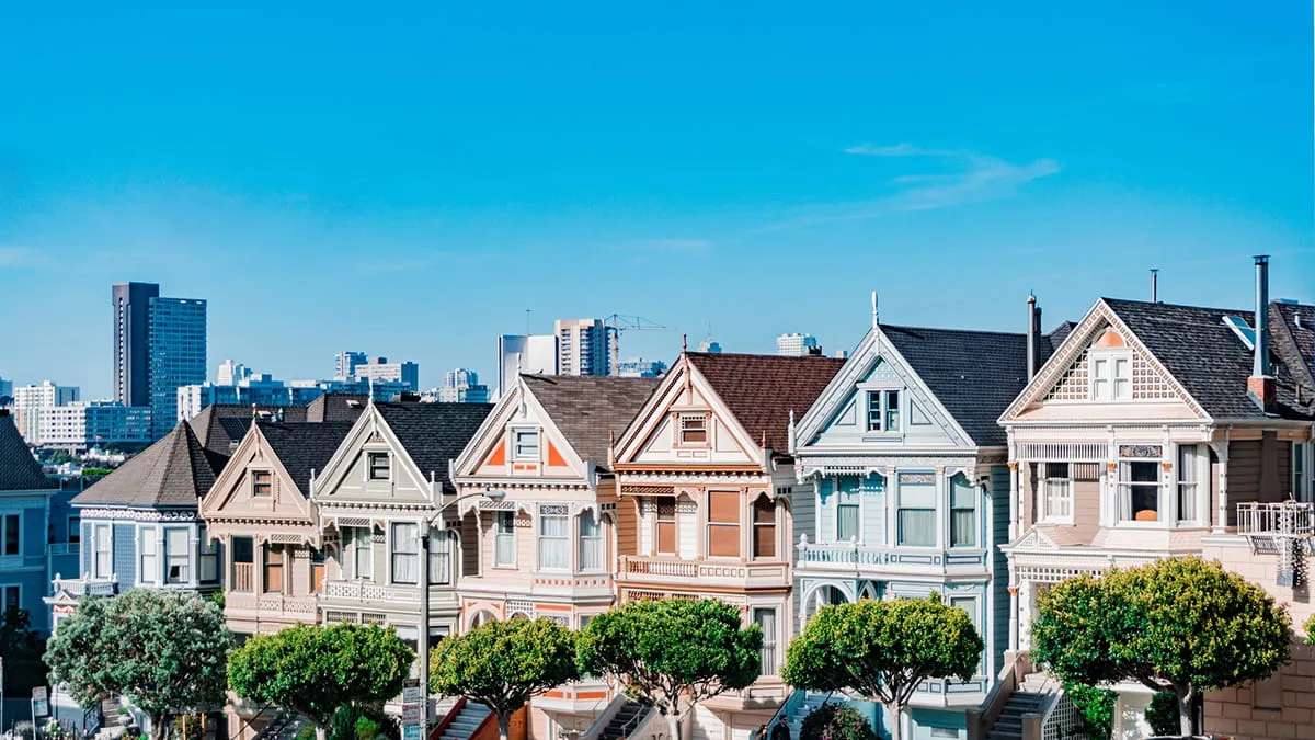 Row of suburban houses under a blue sky