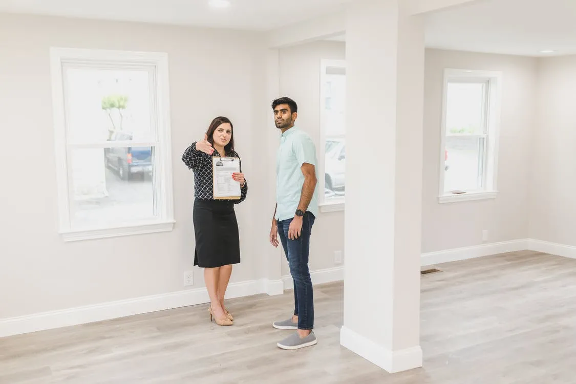Woman showing the inside of house to a man