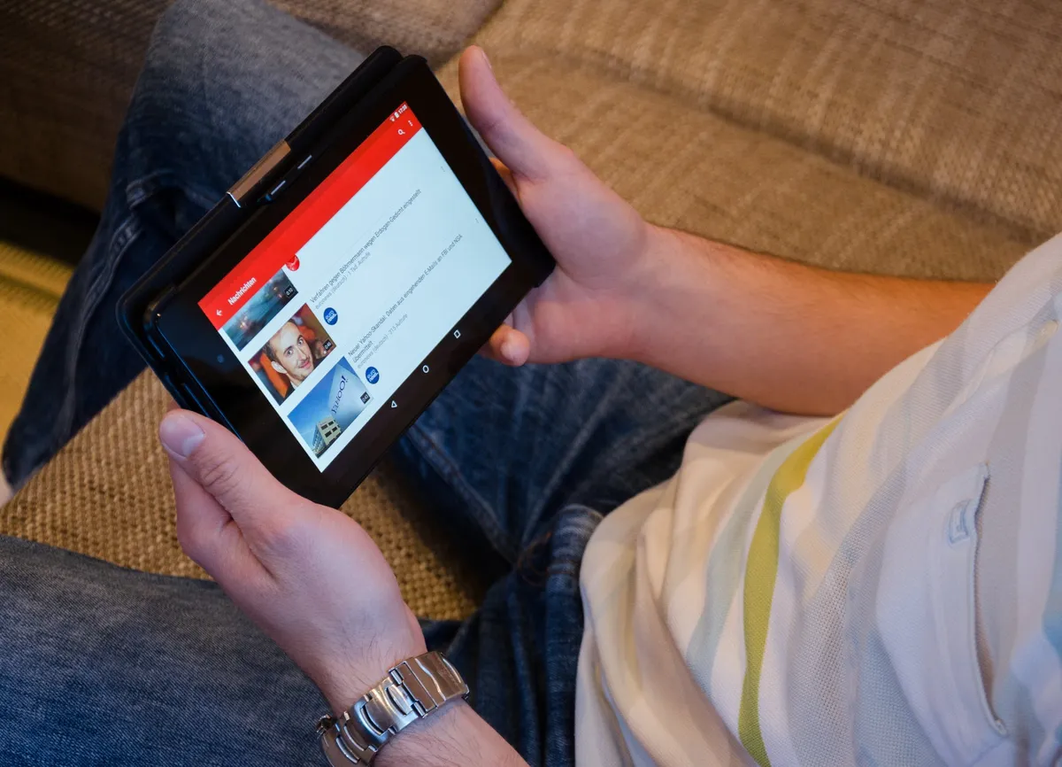 A home buyer watching real estate YouTube videos for relevant home buying tips