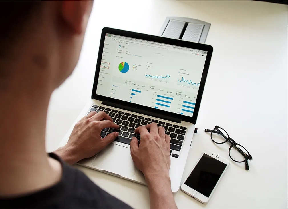 A person reviewing digital marketing numbers on a laptop