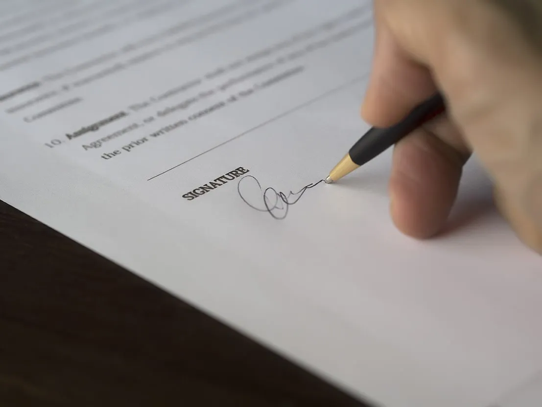 Person signing a letter