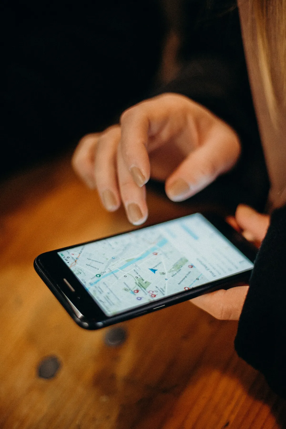 Person holding a smartphone with a map app open