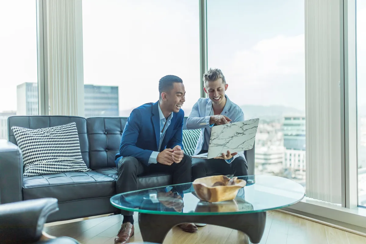 A loan officer and a mortgage officer reviewing local SEO results on a laptop
