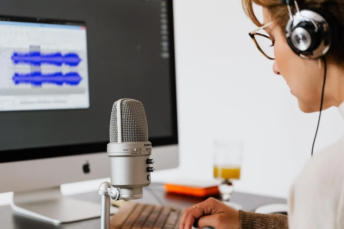 A lone realty podcast host running sound checks before guests arrive