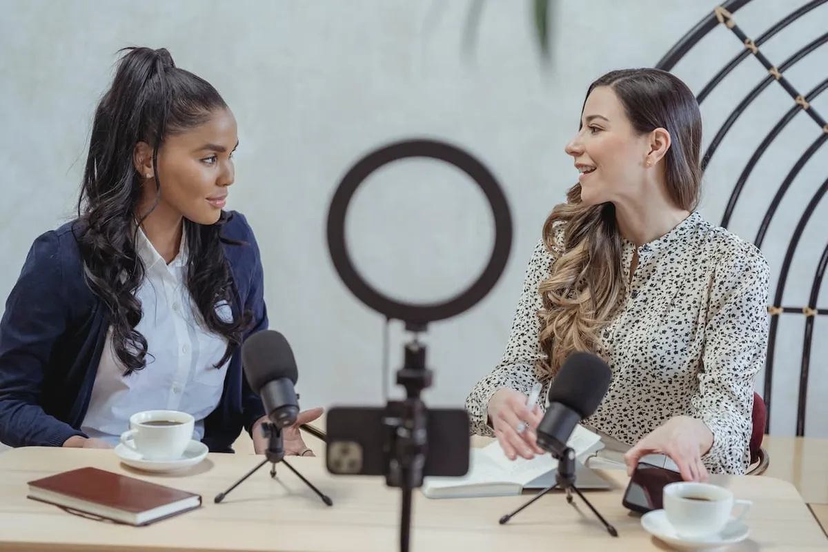 A top-tier realty podcast host directing queries to a guest speaker concerning the sector’s landscape and latest trends