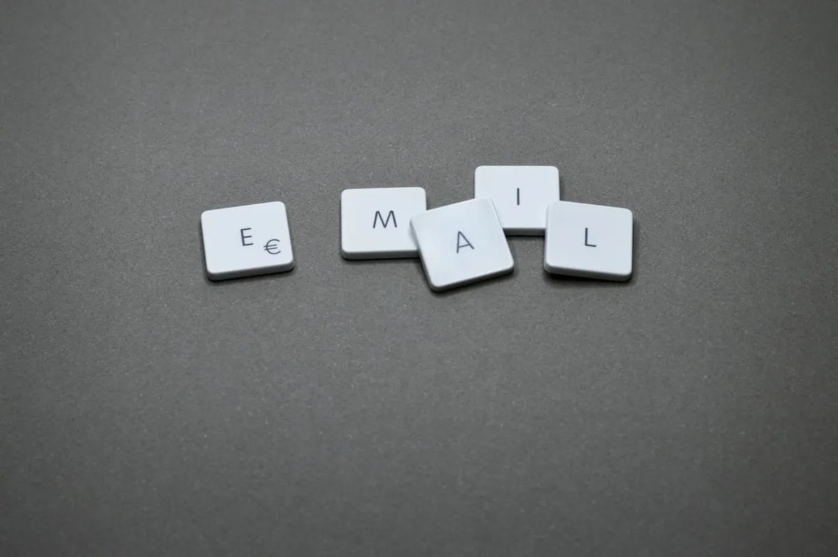 Letter tiles spelling the word email on a gray surface