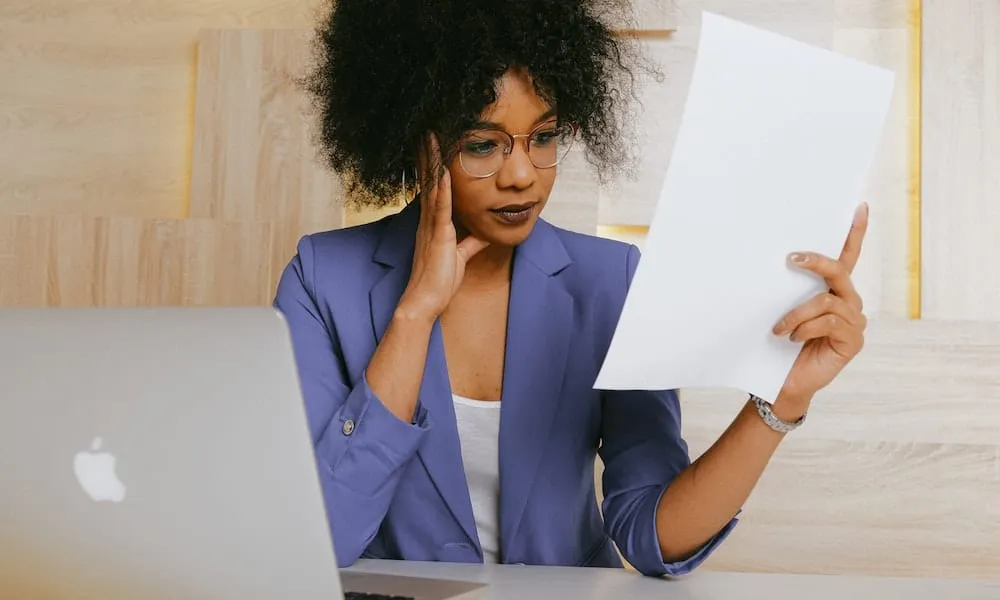 Real estate agent checking out a printed email list for a marketing campaign