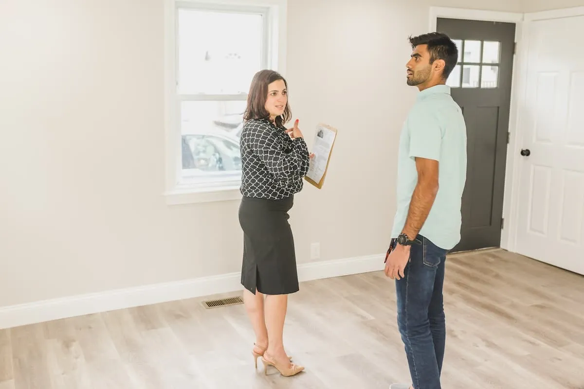 A female agent showing a client through a newly listed property