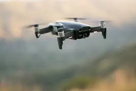 A drone in flight over a blurred landscape