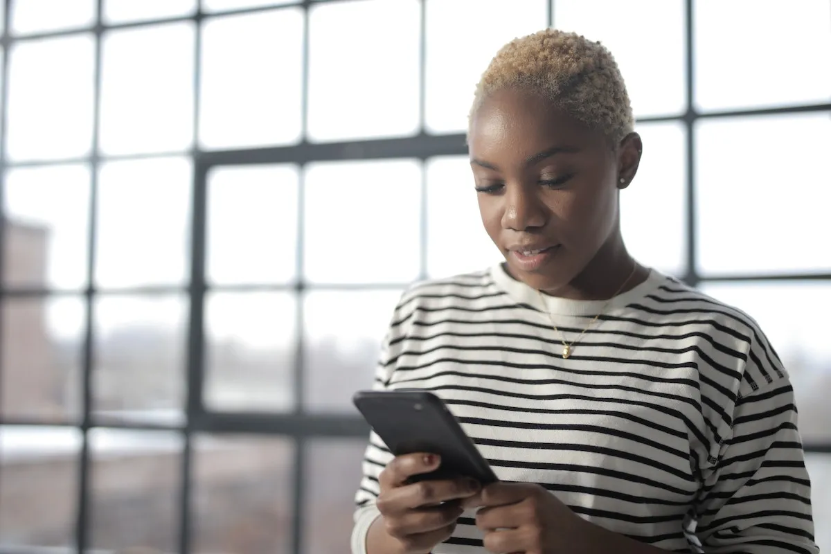Woman browsing a video tour of a listed home on her phone