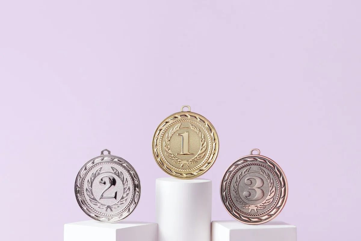 First, second, and third medals on podiums.