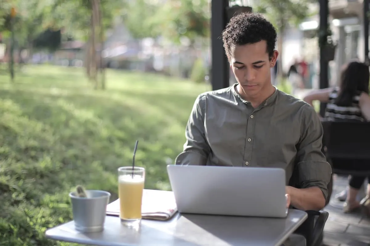 Man using a laptop and browsing through search results of real estate landing pages.