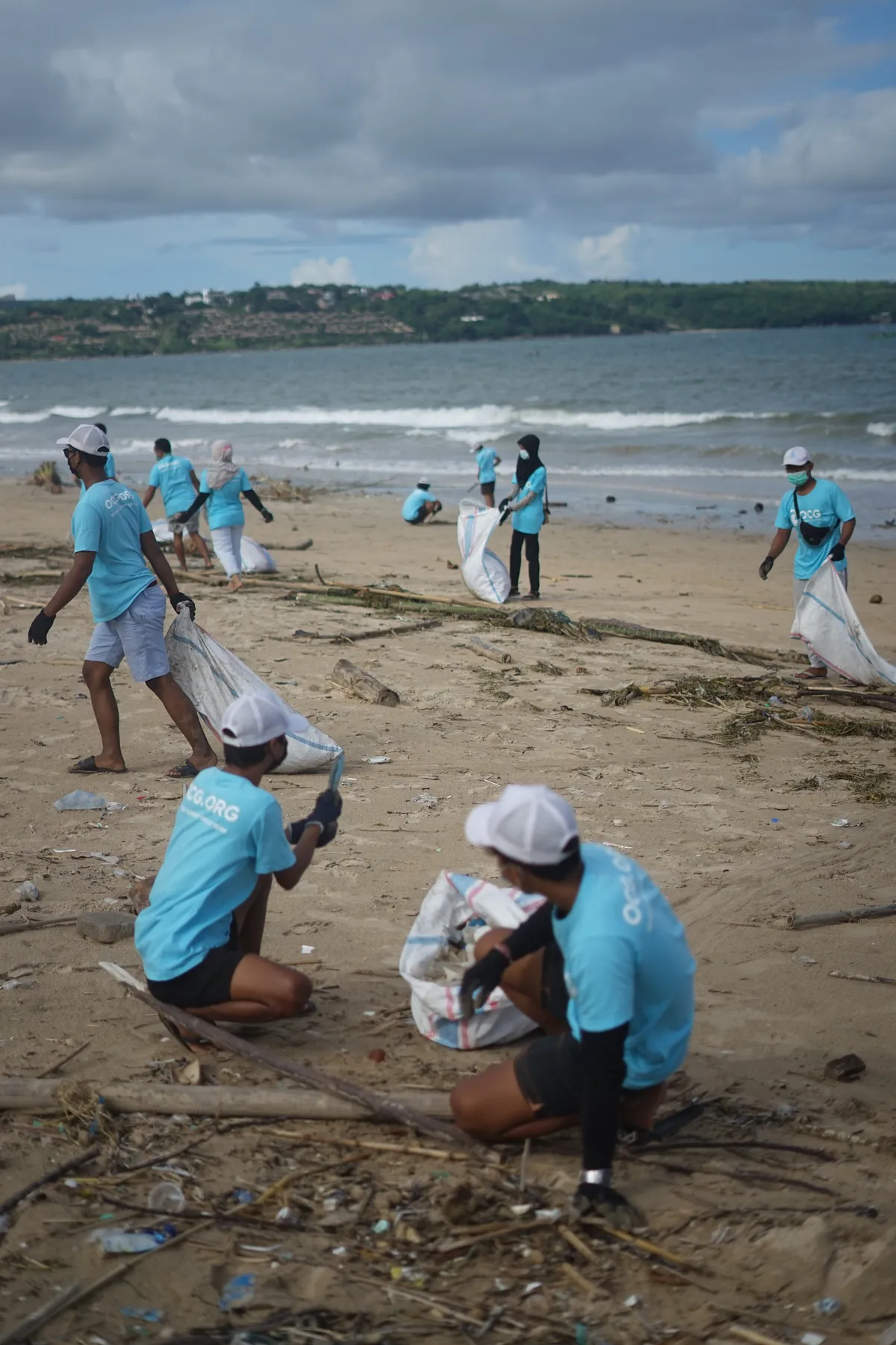Ocean Cleanup Group in Bali, Indonesia removing plastic pollution from a beach.