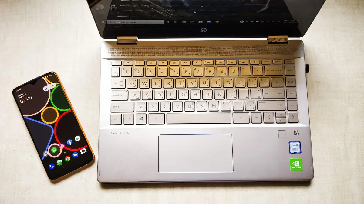Top-down view of a laptop and smartphone.