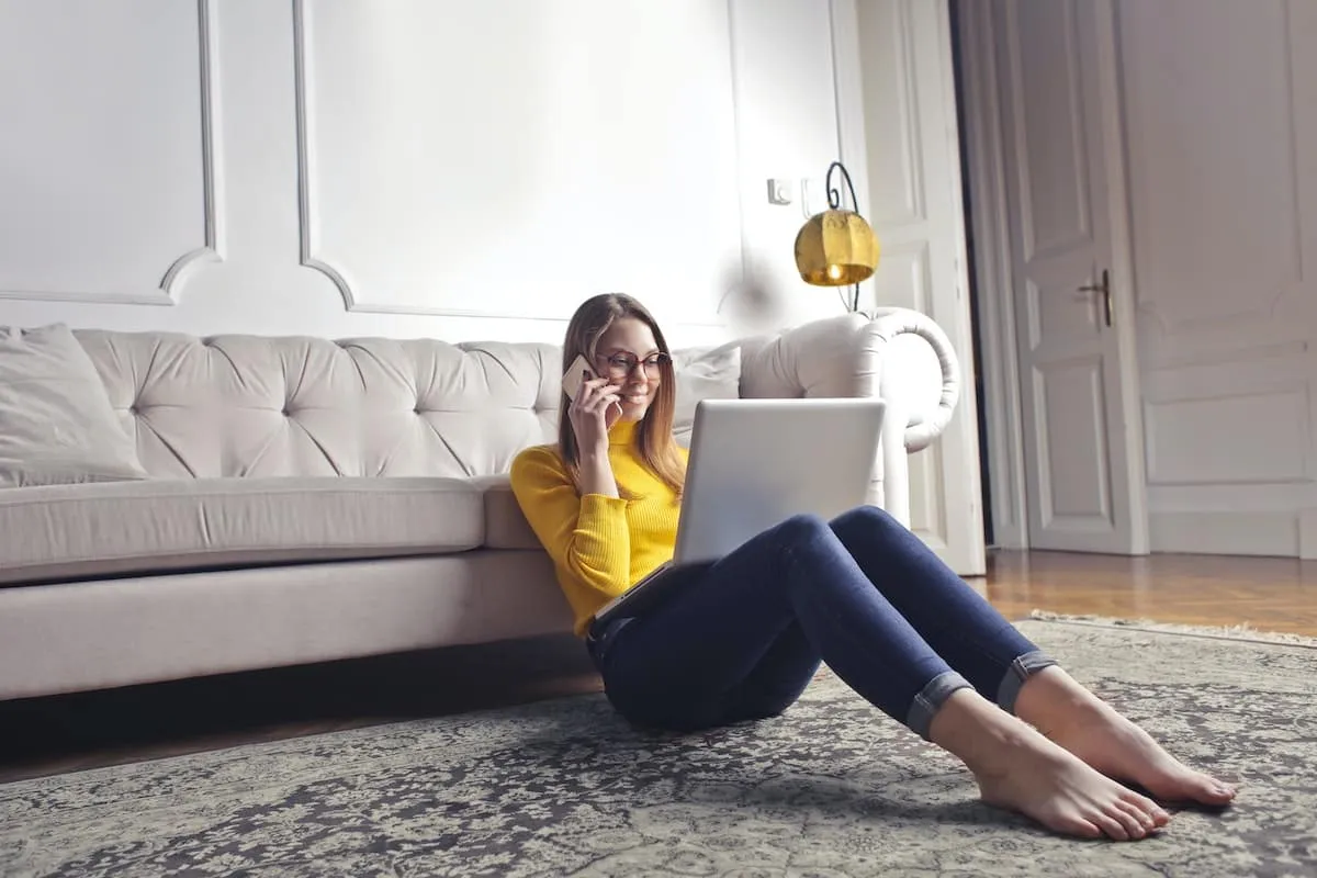 Woman looking at laptop while on the phone.