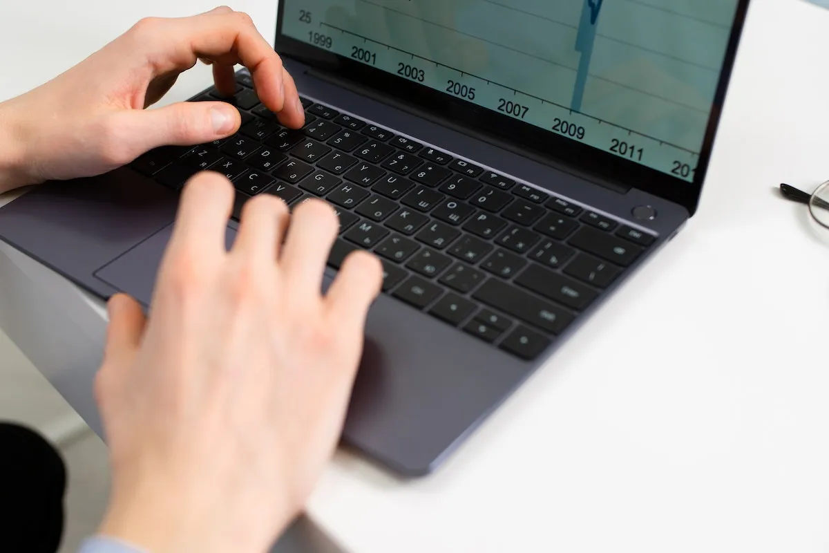 Man looking at analytics for real estate SEO keywords.