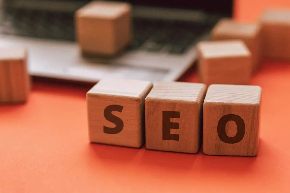 Smartphone held out with a chart of local SEO optimization analytics.