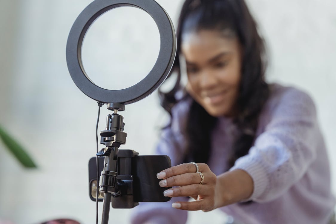A real estate agent setting up her phone camera and ring light to create video content for her YouTube channel