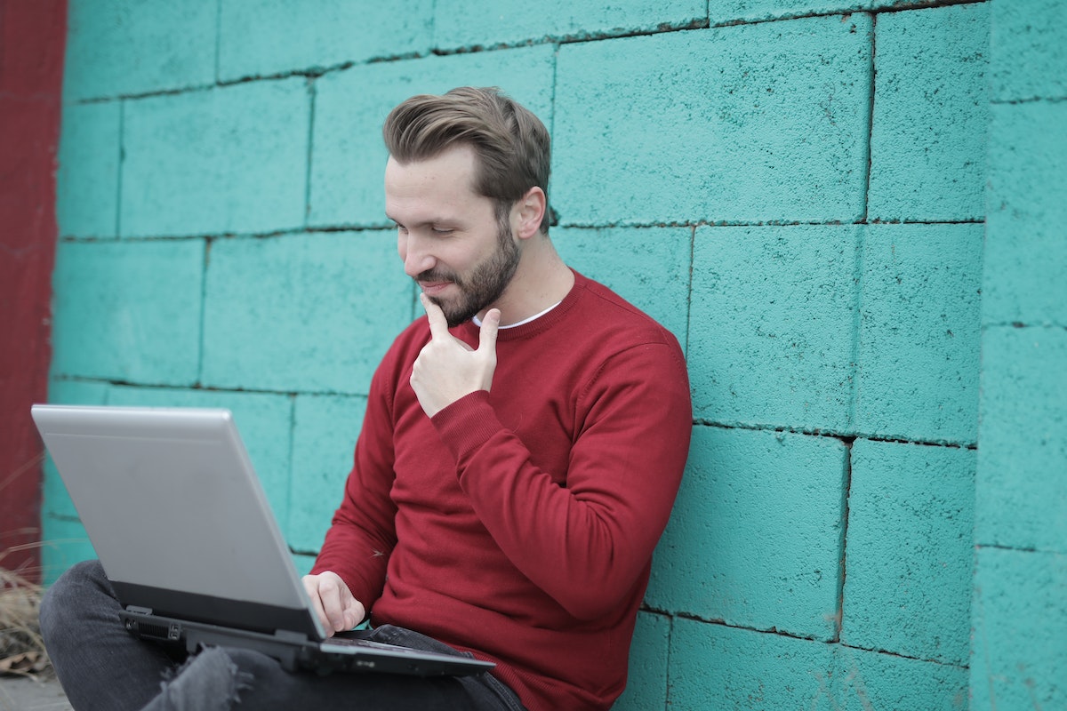 man-in-red-long-sleeve-shirt-using-gray-laptop-computer