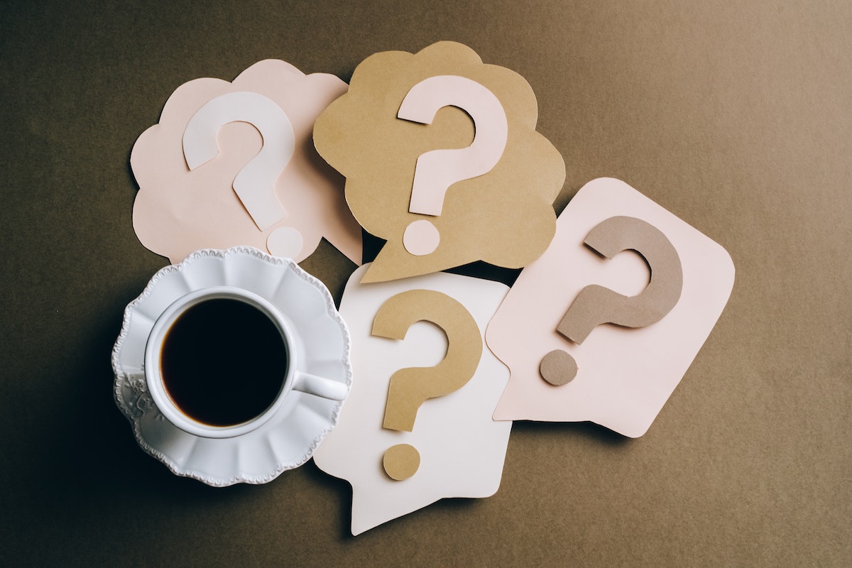 Question Marks on Paper Crafts beside Coffee Drink
