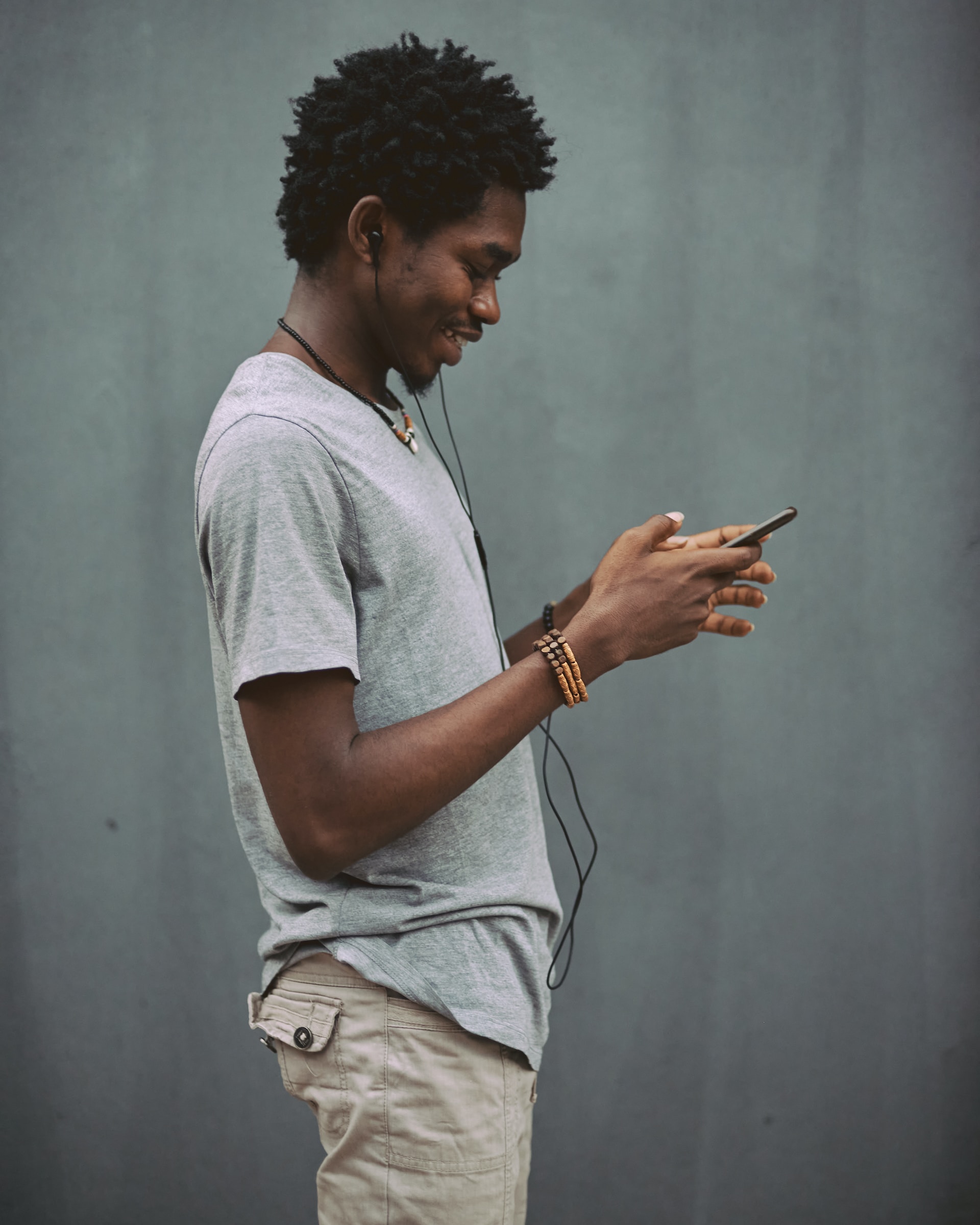 Man using a mobile device to navigate through responsive design.