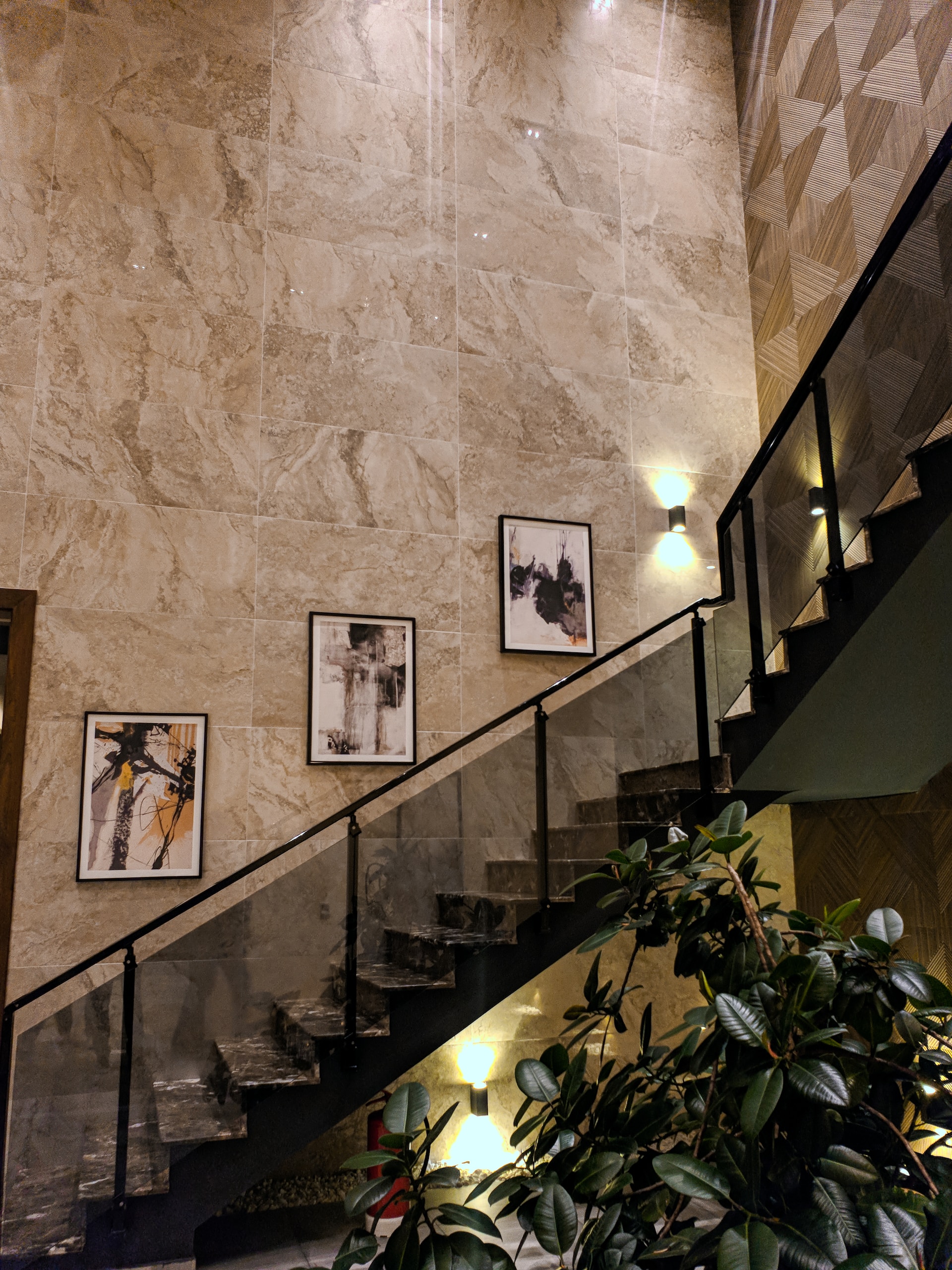 Modern staircase with artwork placed on the walls by a luxury real estate agent.