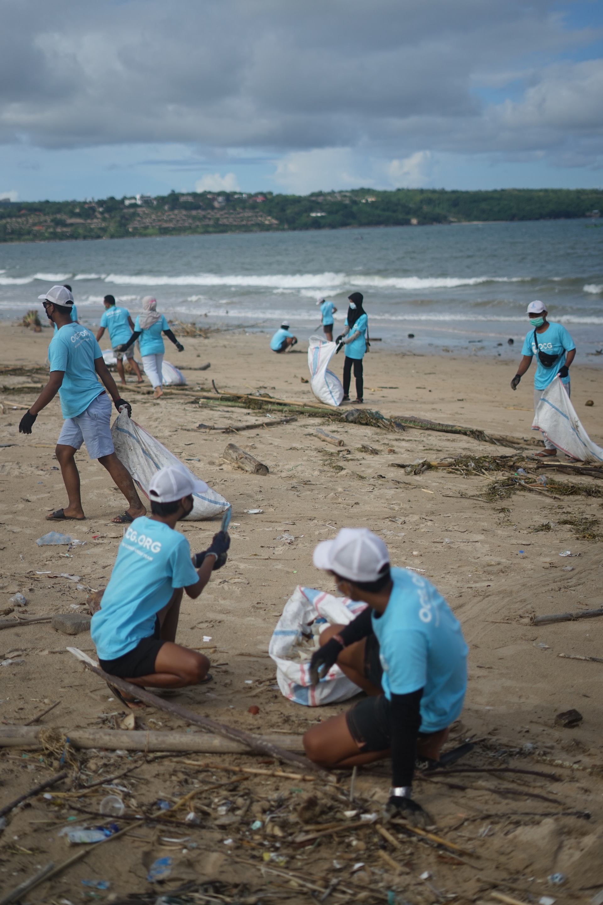 Ocean Cleanup Group in Bali, Indonesia removing plastic pollution from a beach.